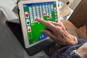 Alert1 Senior Playing on Tablet Alert1 Senior Playing on Tablet