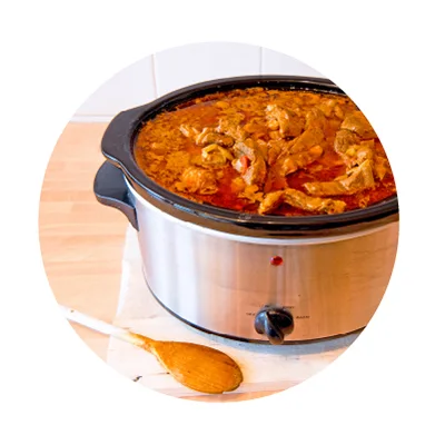 Crockpot with chicken and sauce.  Crockpot with chicken and sauce.