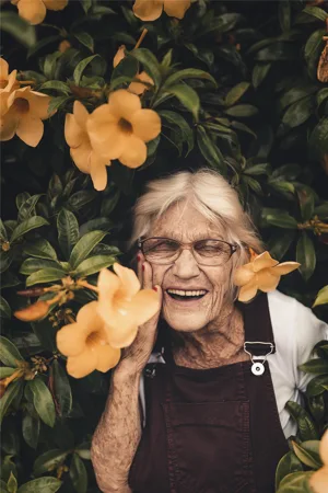 Elderly Lady Smiling In Flowers Elderly Lady Smiling In Flowers