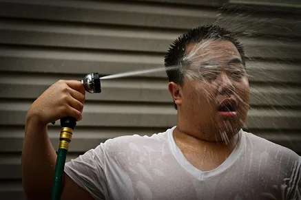 Man cooling himself off with water