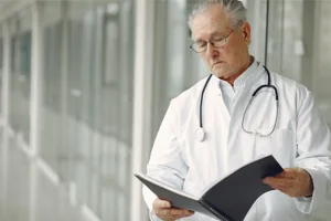Senior Doctor Contemplating Over Case Files Senior Doctor Contemplating Over Case Files