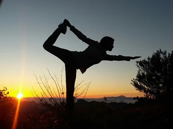 yoga girl stretching outdoors with mobile medical alert yoga girl stretching outdoors with mobile medical alert