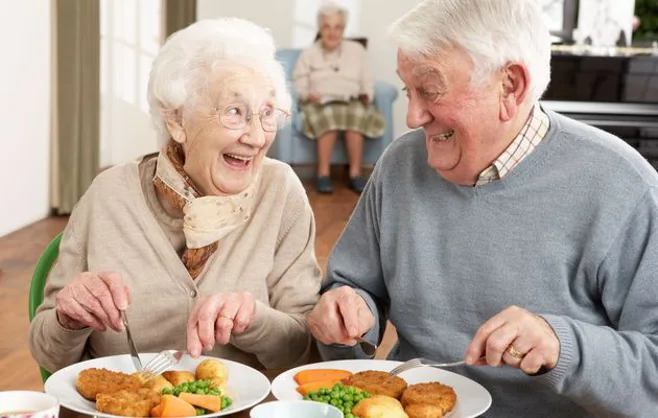 laughing seniors at dinner laughing seniors at dinner