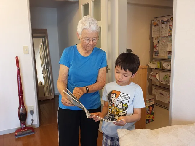 grandma showing grandson a book grandma showing grandson a book