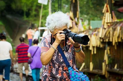 A woman taking a picture with her DSLR camera A woman taking a picture with her DSLR camera