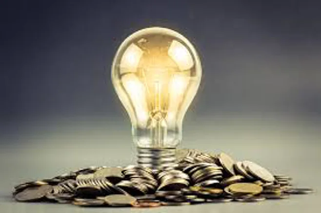 light bulb and coins light bulb and coins