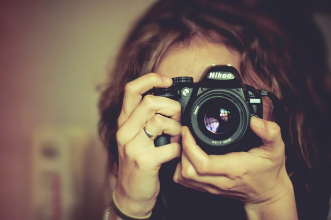 photographer holds nikon photographer holds nikon