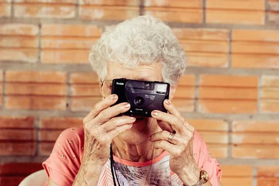 Mom with camera and help button on neck Mom with camera and help button on neck