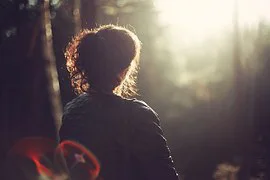 Woman with back to camera facing sun Woman with back to camera facing sun