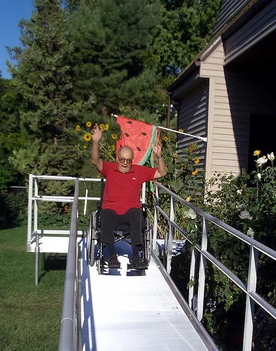 man riding down ramp in wheelchair man riding down ramp in wheelchair