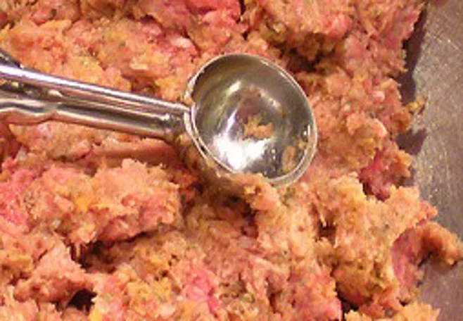 Scooping raw meatball Scooping raw meatball