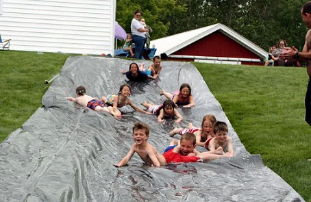 Kids on homemade Slip'n Slide