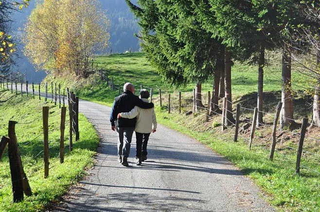 couple walking on rural trail couple walking on rural trail