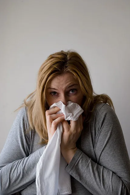 sick woman blowing nose.alert1