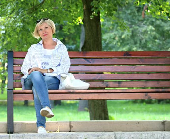 woman sitting on bench woman sitting on bench